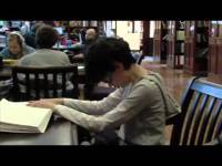 Boy reading a Braille book